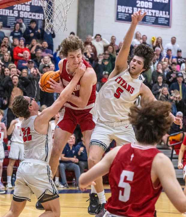 Orange Lutheran's John Gazzaniga, center, grabs a rebound as Tesoro's Nathan Draper, left, and Jake Bennett, right, move in during the Division II regional semifinals in the CIF State boys basketball playoffs at Tesoro High School on Saturday, March 4, 2023 in Las Flores. Orange Lutheran won the game 51-50. (Photo by Mark Rightmire, Orange County Register/SCNG)
